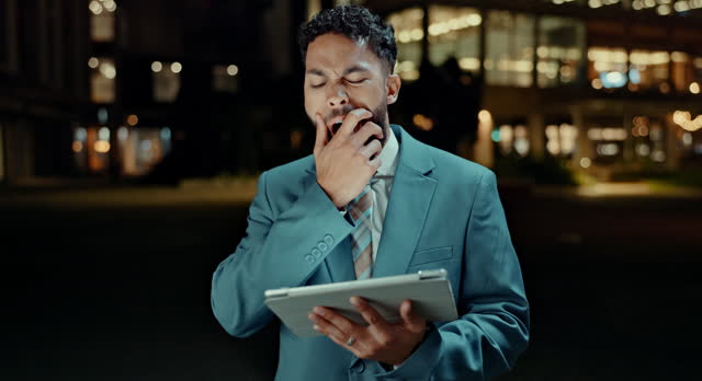 Tablet, yawn or tired businessman in a city at night with low energy, exhausted or bored. Digital, search and male entrepreneur with burnout, fatigue or sleepy while reading client feedback or review