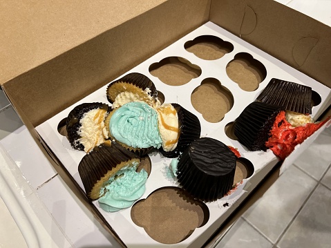 Cupcakes have been smashed and broken in a box as the result of a failed food delivery service order, December 22, 2023