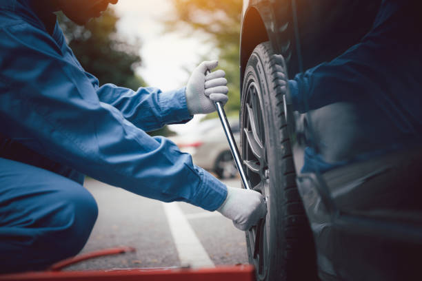 istock Man mechanic changing wheels after car breakdown. 2148836992