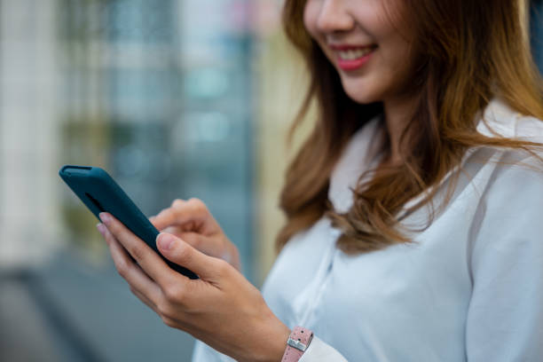 istock A woman in a white shirt using her smartphone for business 2148837010