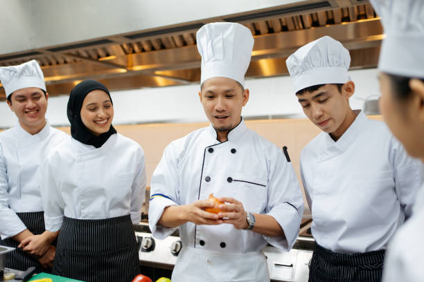 istock Chef teaching a group of students in a cooking class 2148840397