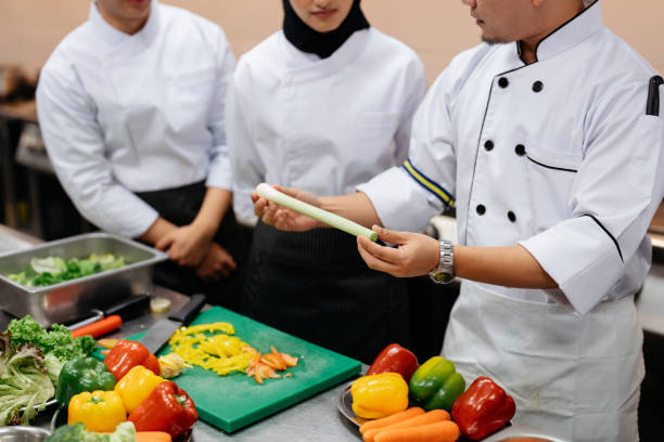 istock Chef teaching a group of students in a cooking class 2148840400