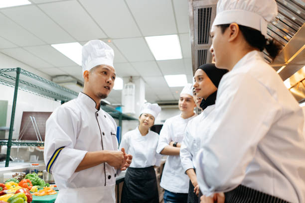 Professional chef conduct a cooking class in commercial kitchen