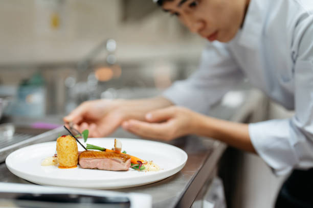 istock Young chef preparing gourmet dish in kitchen 2148840526