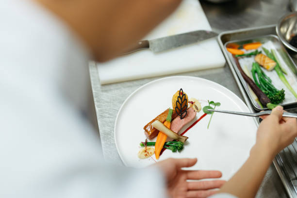 Young chef preparing gourmet dish in kitchen