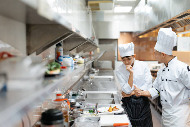 istock Male chef explains about the gourmet dish to cooking class student 2148840546