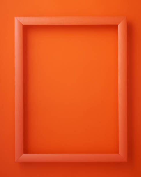 istock Orange wooden picture frame on orange background 2148840707