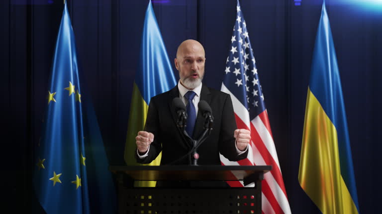 A politician makes a fierce speech with U.S., EU and Ukraine flags on background