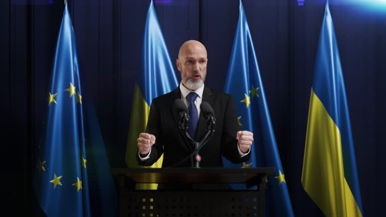 European Union politician gives a fierce speech with EU and Ukraine flags on bg