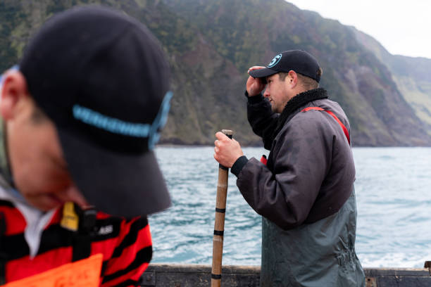 istock Fisherman standing on a boat working patiently 2148840924