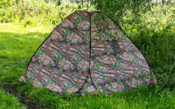 Tourist tent on green grass.