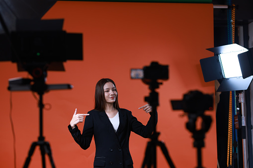 Back state of a young  female model in studio  steadicam during the shooting of a commercial  advertisement