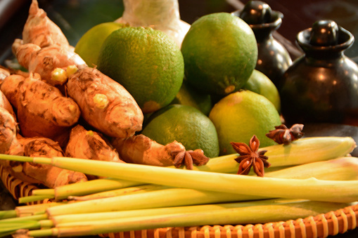 still life composition: Spice basket with fresh lime fruit,star anice ,ginger and lemon grass.