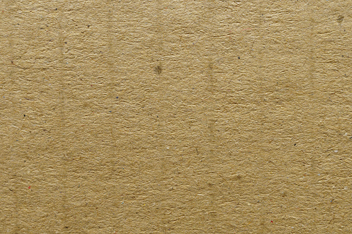 High-resolution image of handmade yellow paper with a natural and organic texture, ideal for design backgrounds.