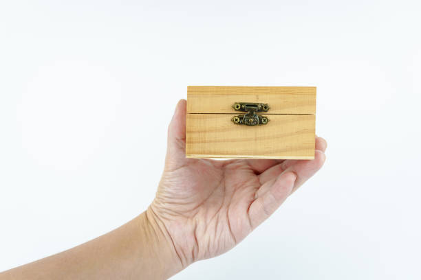 istock hand holding small wooden box on white background. 2148844532