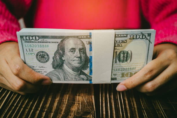 istock Female hands holding banknotes, finance concept 2148844734