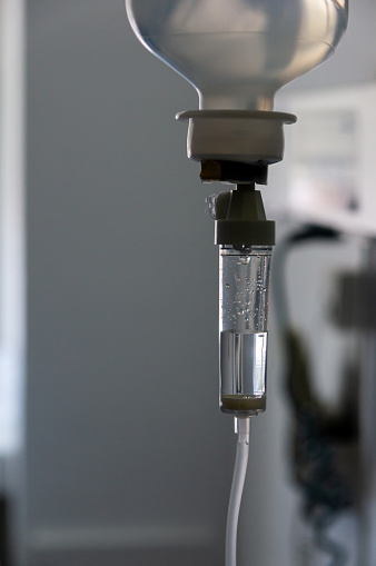 Intravenous Care in the Hospital: Detail of a Dropper Administering Medication or Serum to the Patient.
