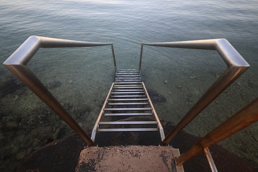 Metal stairs to the entrance of the sea.