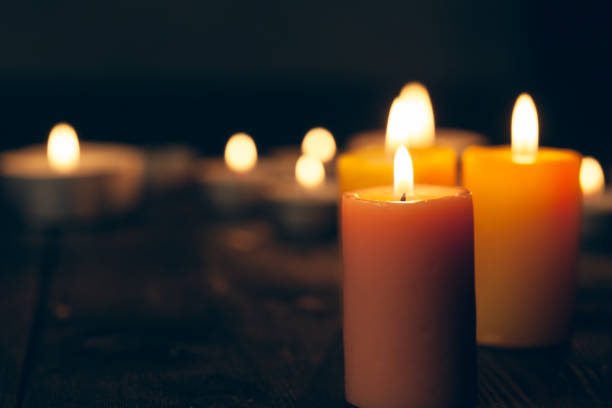istock candles burning in darkness over black background. commemoration concept. 2148847205