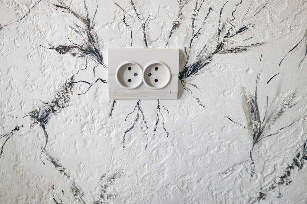 istock Socket for the electricity on the wall. Beautiful light  background texture with black and grey lines and . Abstract background from plaster on wall around socket 2148847581