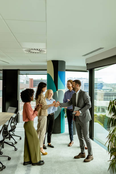 A warm handshake welcome during a sunny morning office gathering
