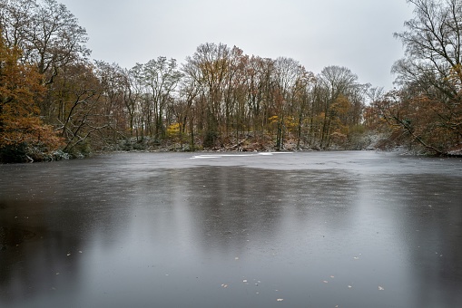 slightly frozen lake in winter