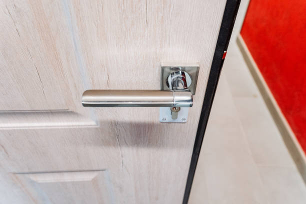 Silver handle of the front door to the house, top view of the handle of the holder, door to the apartment. Silver handle of the front door to the house, top view of the handle of the holder, door to the apartment. High quality photo frosted glass door office stock pictures, royalty-free photos & images
