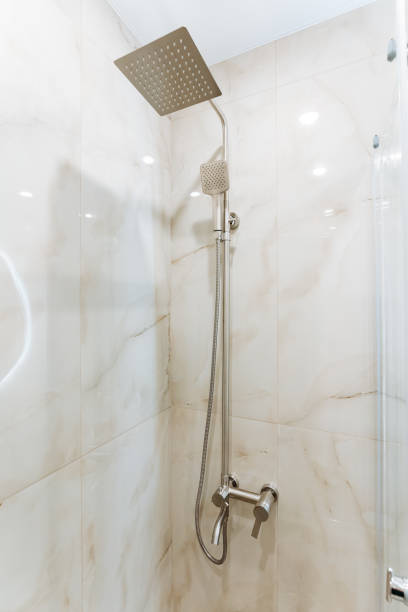 istock Plumbing fixture hanging from shower bar on bathroom ceiling 2148849066