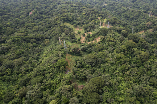 Electic tower in among green landscape aerial drone view