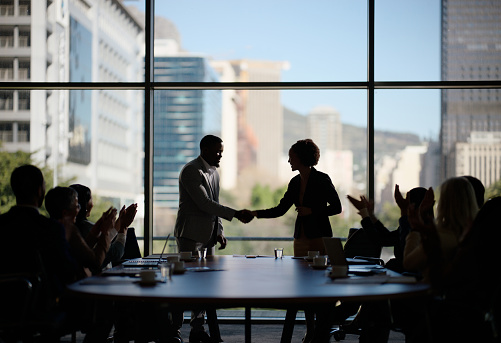 Business people, clapping and handshake for deal in boardroom, merger and proud of company win. Partners, applause and thank you for teamwork or success, contract and united in global acquisition