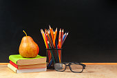 Color pencil in the cup on wooden background