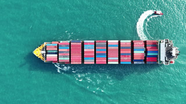 Cargo Container ship running with pilot boat in the ocean. sea port. container ship import export to customers sea port. export shipping industry freight and transportation logistics concept.