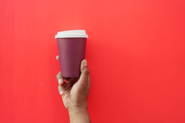 istock holding a red take away kraft coffee cup 2148853293