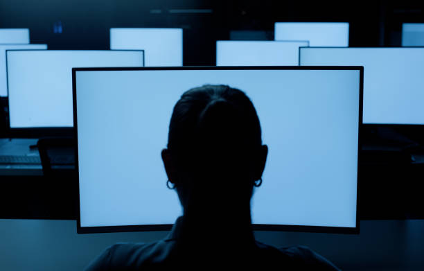 istock Back of person, computers or screen at night in information technology lab with developer or programmer. Software development, networking and system administration for digital machine or connection 2148853348