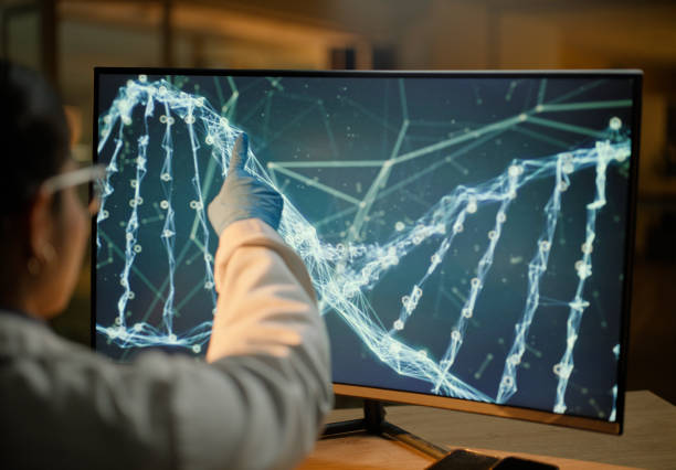 Woman, computer screen and dna ​for lab biotechnology or gene therapy or anti aging science, futuristic or innovation. Female person, pointing and double helix for medical, research or chromosome