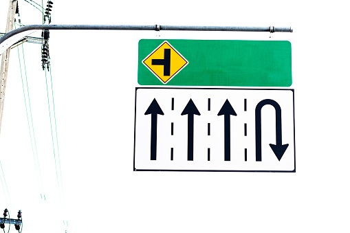 Road sign with arrows for several lanes and u-turn high up in Bangkok