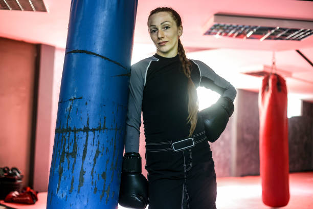 Young woman exercising kickboxing. About 30 years old, Caucasian female.
