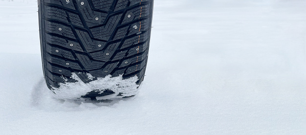 Winter tires with spikes in the snow.