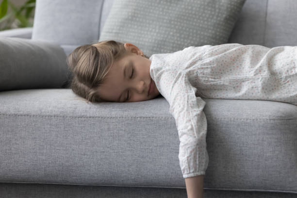istock Child closed eyes lying on couch at home rest alone 2148855516