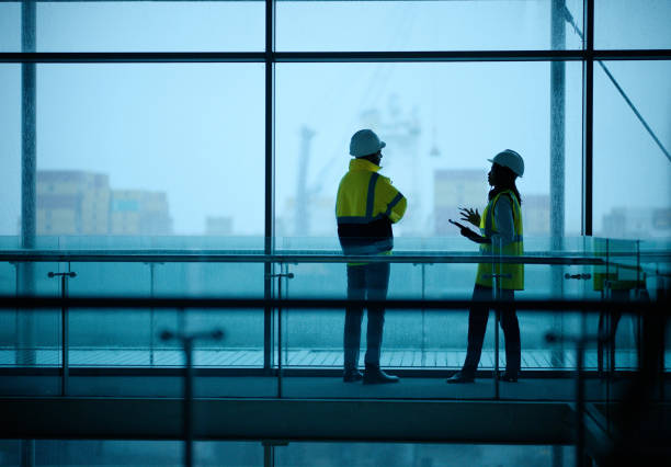 istock Construction, tablet and teamwork with building project, people and renovation with inspection. Schedule, architects or industrial with support or protection with safety, engineering or collaboration 2148855670
