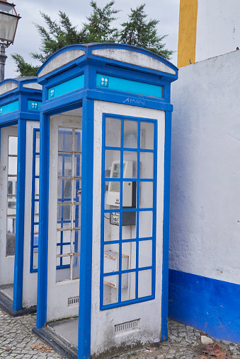 pair of blue/white phone booths on street corner. Lisbon, Portugal.  Portugal tour. October 2023