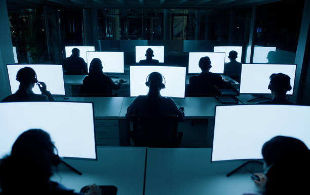 istock Computer screen, control room and headset in call centre people, night or mockup space for online worker. Technology, desktop or digital work on internet for employees, dark or deadline for staff 2148855958