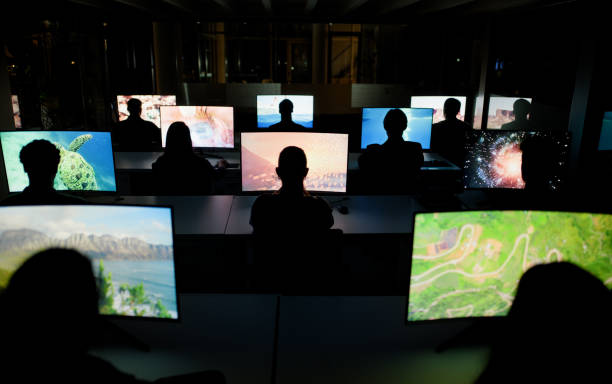 istock Employees, night and computer screens in centre, cyber security or information observation on technology pc. Collaborative, workspace or team in office, back view and colleagues working together 2148855959