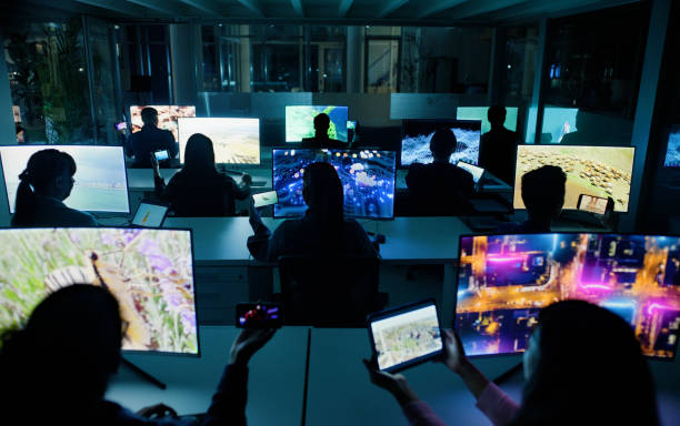 istock Technology, night and computer screens in centre, streaming or videographer with content creation with people. Collaborative, workspace and team in office, back view or colleagues working together 2148855960