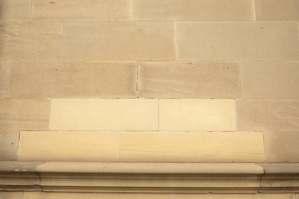 istock Close up of sandstone block wall on building with new replacement blocks 2148856401