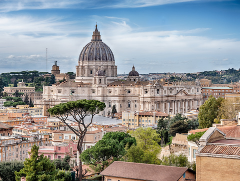 Rome, Italy - March 30, 2023: The Basilica of St. Peter dominates the skyline of the Vatican City enclave in Rome.