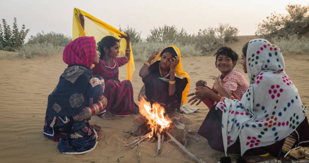 istock Indian kids setting up bonfire on sand dune 2148858643