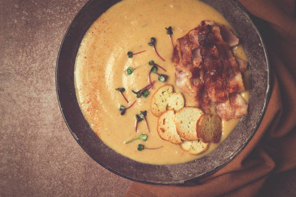 istock Pumpkin cream soup, curry, fried bacon, bruschetta chips,micro-greens, top view, no people, 2148858666