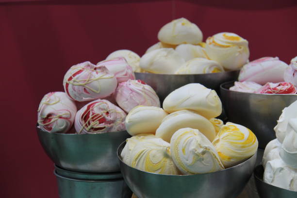 Italian food background: Delicious meringue cookies in Italian flag colors and various tastes.  View from a patisserie window with price label.