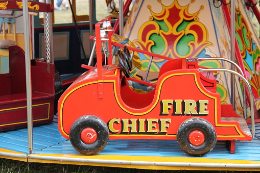 A Wooden Fire Engine on a Childrens Fun Fair Ride.